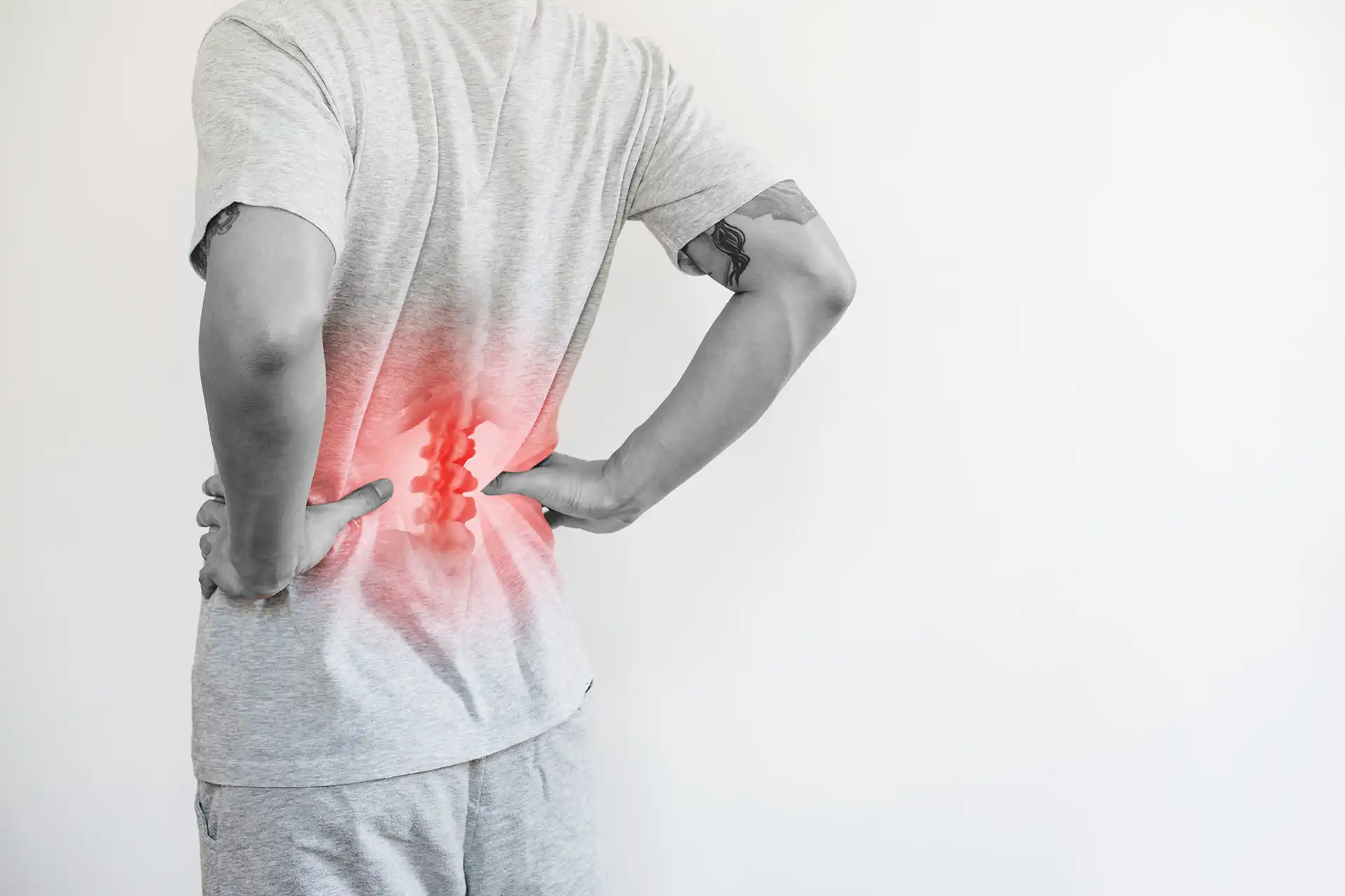 Office syndrome, Backache and Lower Back Pain Concept. a man touching his lower back at pain point